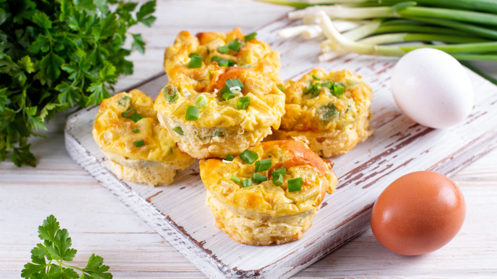 A cutting board holding five egg bites