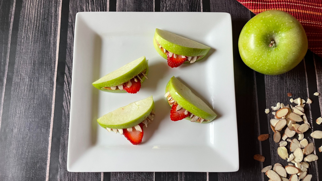 A plate with healthy apple monster mouth snacks on it